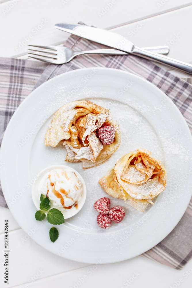 Crepes Pancakes with fruit jam and ice cream. Top view on white wooden table Crepes Pancakes with fruit jam and ice cream. Top view on white wooden table