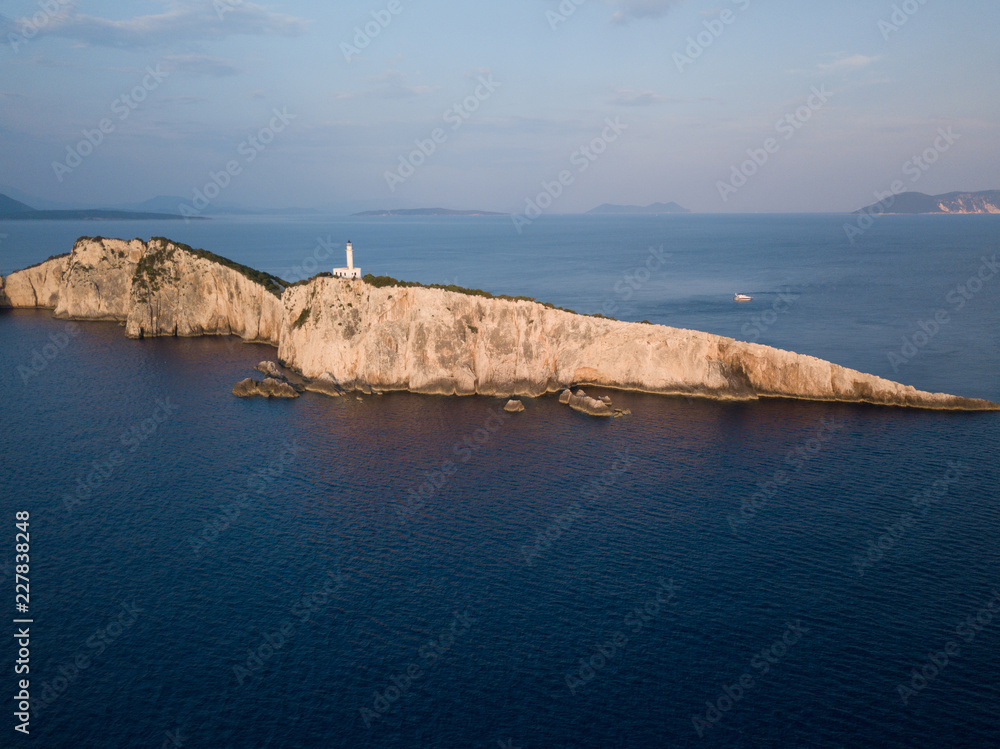 Lighthouse high above the sea at golden hour, in Lefkada, Greece