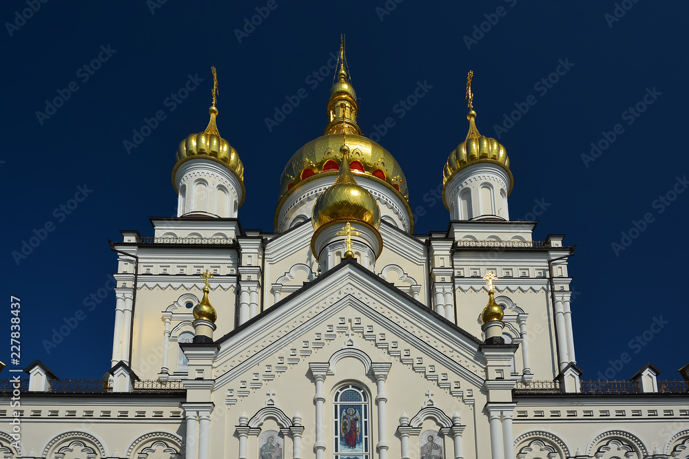 Obraz premium Religious building, Orthodox Christian cathedral with golden domes. Transfiguration Cathedral, Holy Dormition Pochayiv Lavra in Ukraine.