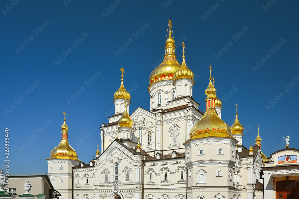Religious building, Orthodox Christian cathedral with golden domes. Transfiguration Cathedral, Holy Dormition Pochayiv Lavra in Ukraine. Religious building, Orthodox Christian cathedral with golden domes. Transfiguration Cathedral, Holy Dormition Pochayiv Lavra in Ukraine.