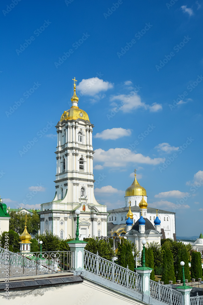 Religious buildings, Orthodox Christian cathedral with golden domes. Huge religious complex. Bell tower and Trinity Cathedral, Holy Dormition Pochayiv Lavra in Ukraine.