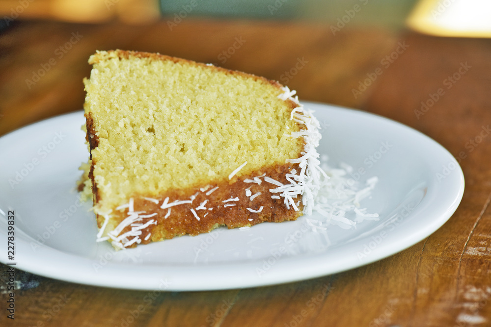 Slice of homemade cake with coconut flakes