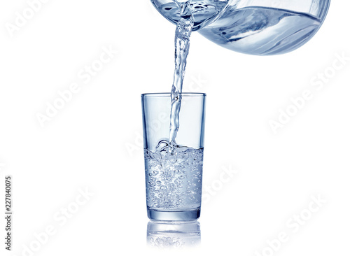 puring water into glass isolated on whtie background