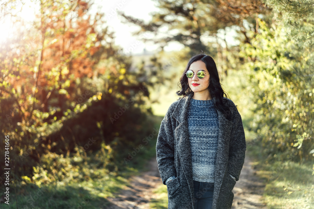 Pretty long hair bruntte girl walking in the autumn forest. Pretty long hair bruntte girl walking in the autumn forest.