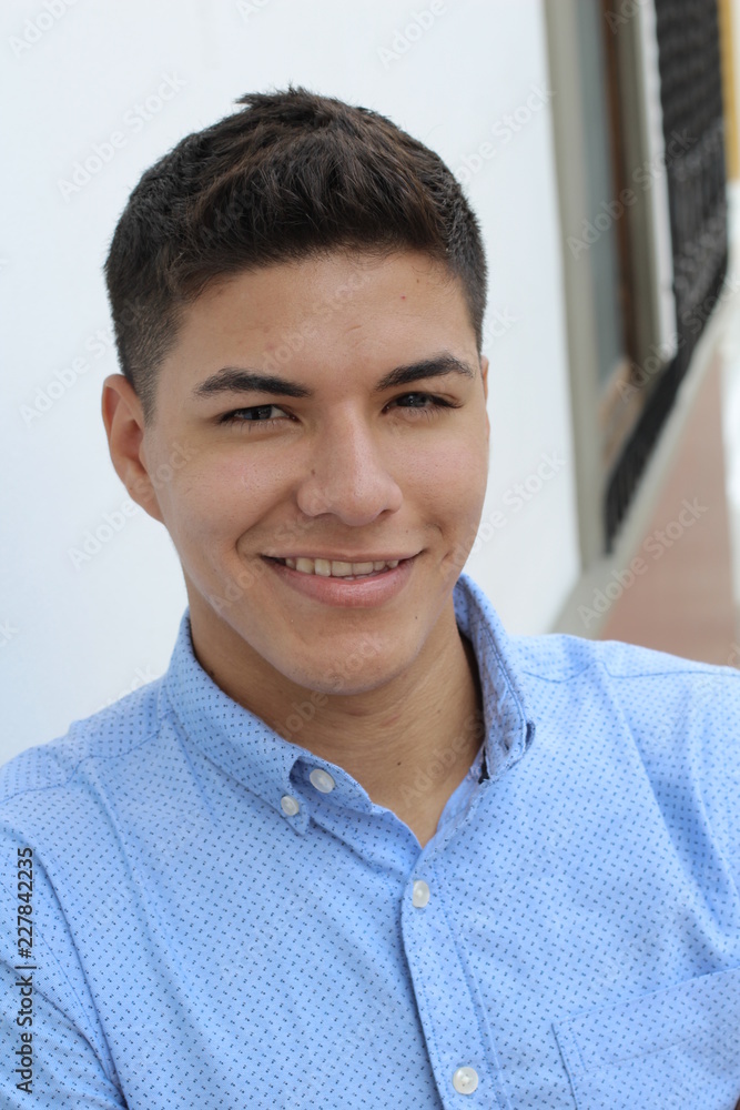 Young hispanic male wearing blue button up Young hispanic male wearing blue button up