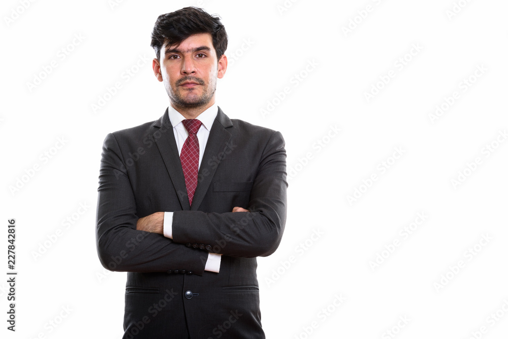 Studio shot of young Persian businessman with arms crossed Studio shot of young Persian businessman with arms crossed