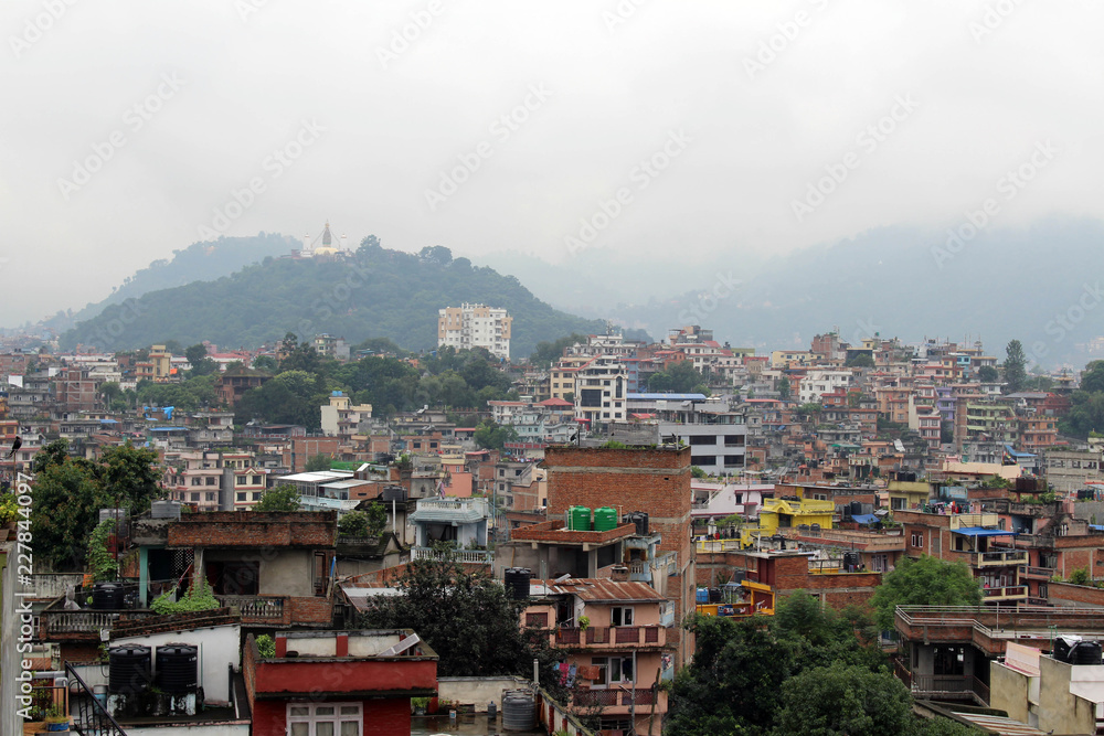 The view of Swayambhunath Stupa from the rooftop in Kathmandu during cloudy day