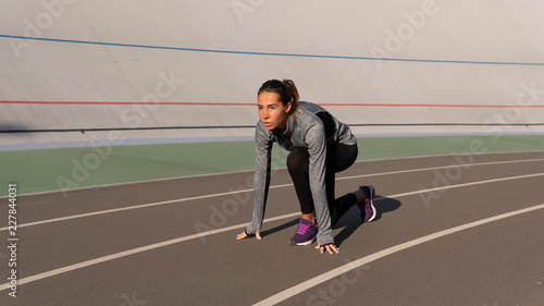 Independed brunette woman preparing for the run on the runner track