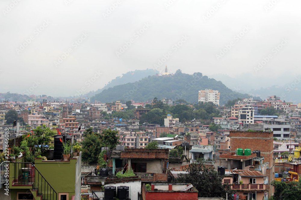 The view of Swayambhunath Stupa from the rooftop in Kathmandu during cloudy day