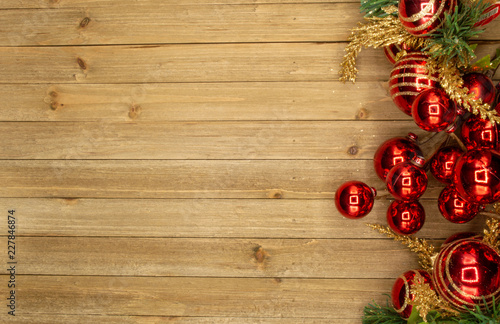 Holiday wood background with red ornaments