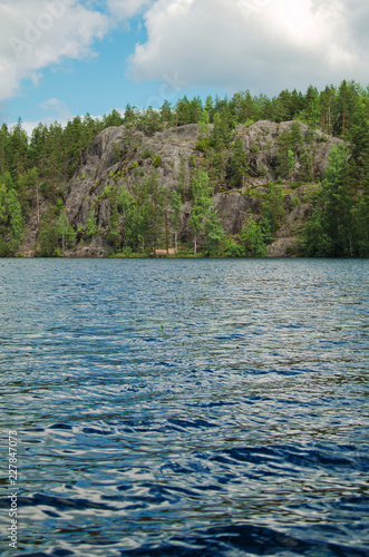 craggy rocks covered with forest over North lake