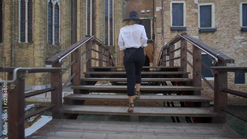 Girl walking in venice, Italy, seeing over antique and beautiful city Girl walking in venice, Italy, seeing over antique and beautiful city