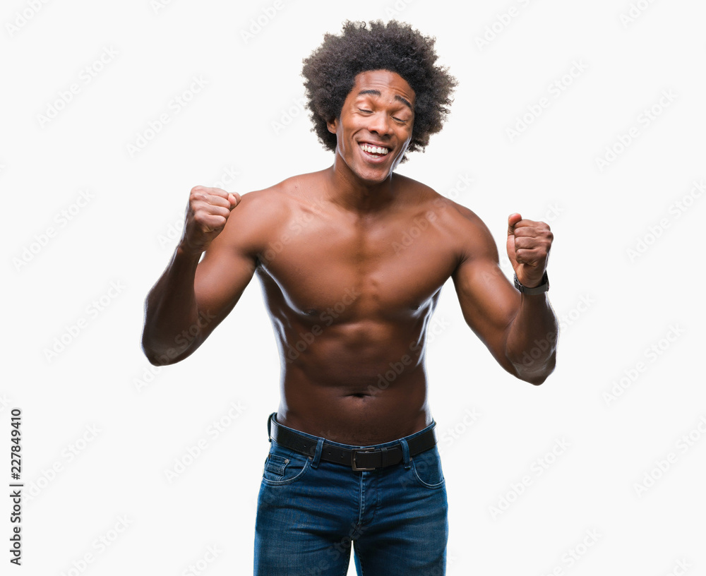 Afro american shirtless man showing nude body over isolated background excited for success with arms raised celebrating victory smiling. Winner concept. Afro american shirtless man showing nude body over isolated background excited for success with arms raised celebrating victory smiling. Winner concept.