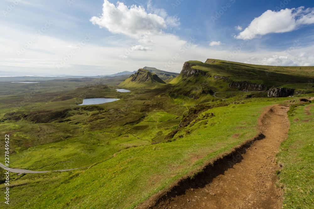 Stunning Quiraing trail view over the green cliffs lochs and trail on the Isle of Skye in Scotland