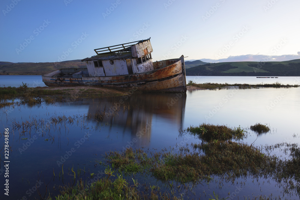 Old boat shipwrecked in the murky waters