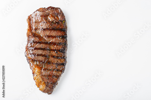 grilled marbled beef steak striploin isolated on white background, top view with copy space