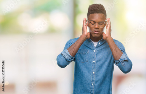 Young african american man over isolated background with hand on head for pain in head because stress. Suffering migraine.