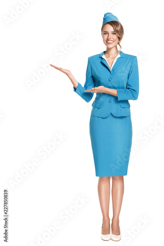 Portrait of charming stewardess wearing in blue uniform. Isolated on white background. photo