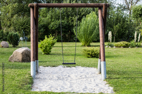  wooden swing in the garden