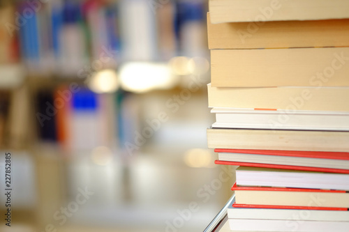 Stack of books on a shelf in a library © Elena Krivorotova