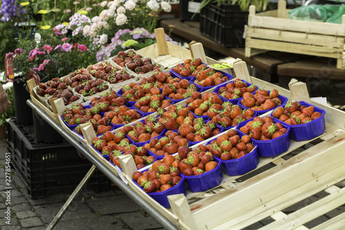Fresh Strawberries for sale on a stand in a fruit market