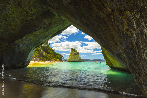 Landscape View through rock arch towards Te Hoho Rock at Cathedral Cove, Coromandel Peninsula - New Zealand