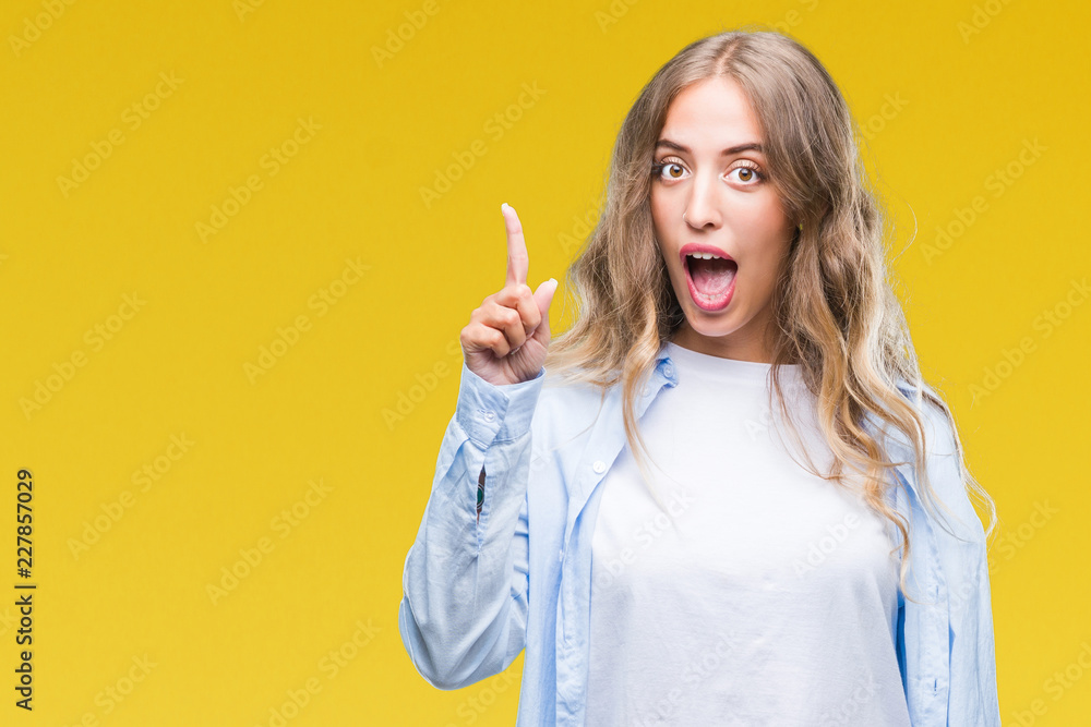 Beautiful young blonde woman over isolated background pointing finger up with successful idea. Exited and happy. Number one. Beautiful young blonde woman over isolated background pointing finger up with successful idea. Exited and happy. Number one.