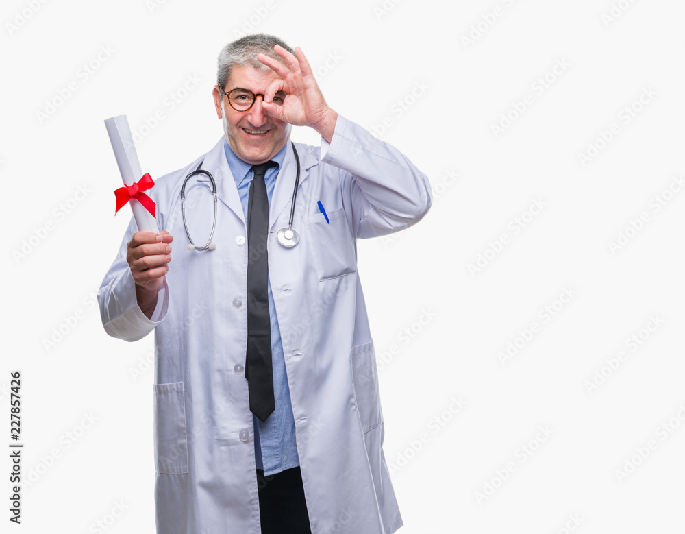 Handsome senior doctor man holding degree paper over isolated background with happy face smiling doing ok sign with hand on eye looking through fingers Handsome senior doctor man holding degree paper over isolated background with happy face smiling doing ok sign with hand on eye looking through fingers