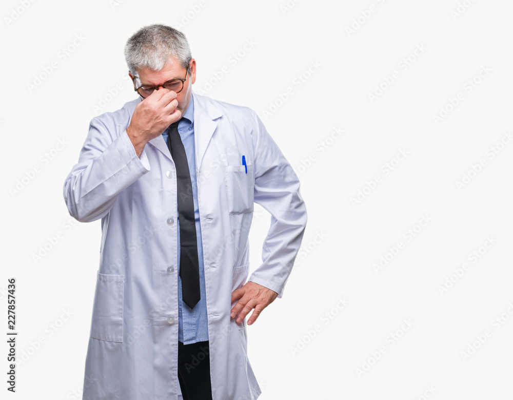 Handsome senior doctor, scientist professional man wearing white coat over isolated background tired rubbing nose and eyes feeling fatigue and headache. Stress and frustration concept.