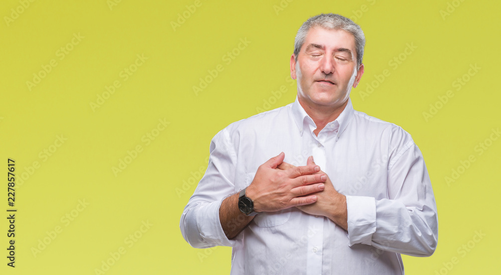 Handsome senior man over isolated background smiling with hands on chest with closed eyes and grateful gesture on face. Health concept. Handsome senior man over isolated background smiling with hands on chest with closed eyes and grateful gesture on face. Health concept.