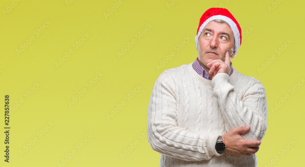 Handsome senior man wearing christmas hat over isolated background with hand on chin thinking about question, pensive expression. Smiling with thoughtful face. Doubt concept. Handsome senior man wearing christmas hat over isolated background with hand on chin thinking about question, pensive expression. Smiling with thoughtful face. Doubt concept.