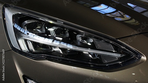 Sleek LED headlight of modern american compact SUV car. 