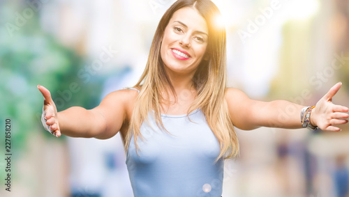 Wallpaper Mural Young beautiful elegant business woman over isolated background looking at the camera smiling with open arms for hug. Cheerful expression embracing happiness. Torontodigital.ca