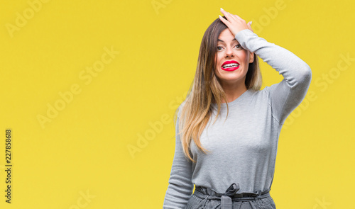 Young beautiful worker business woman over isolated background surprised with hand on head for mistake, remember error. Forgot, bad memory concept.