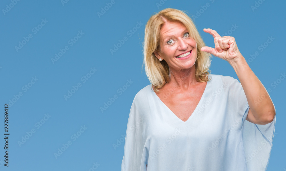 Fototapeta premium Middle age blonde business woman over isolated background smiling and confident gesturing with hand doing size sign with fingers while looking and the camera. Measure concept.