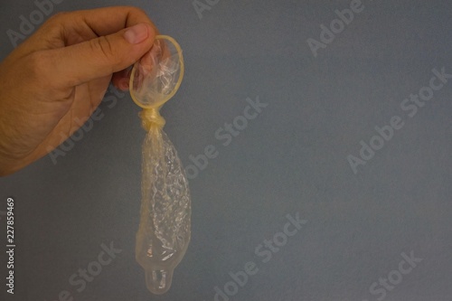 Knotted condom in hand. photo