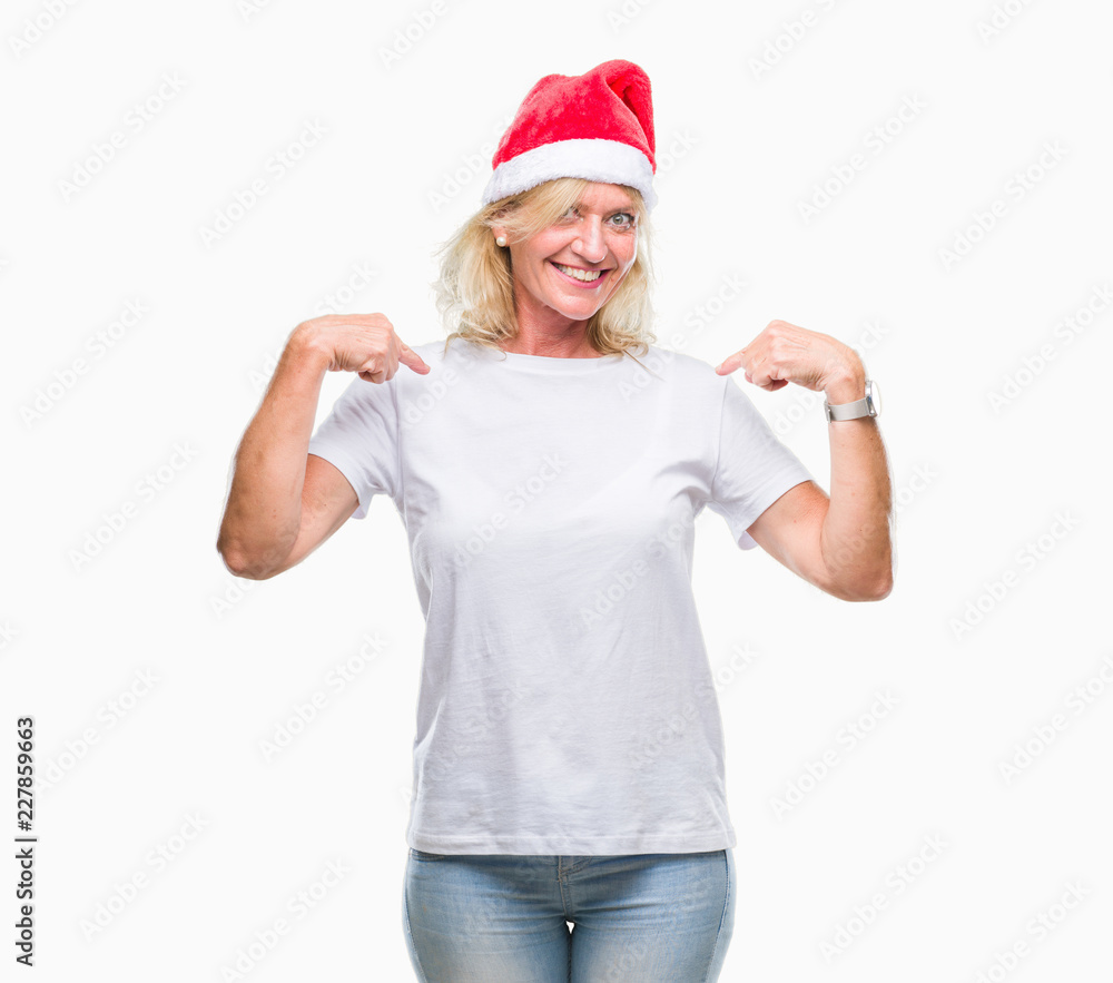 Middle age blonde woman wearing christmas hat over isolated background looking confident with smile on face, pointing oneself with fingers proud and happy. Middle age blonde woman wearing christmas hat over isolated background looking confident with smile on face, pointing oneself with fingers proud and happy.