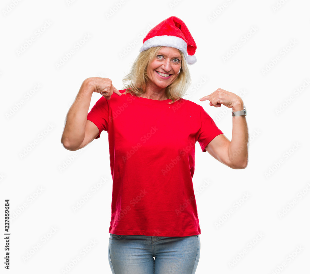Middle age blonde woman wearing christmas hat over isolated background looking confident with smile on face, pointing oneself with fingers proud and happy. Middle age blonde woman wearing christmas hat over isolated background looking confident with smile on face, pointing oneself with fingers proud and happy.