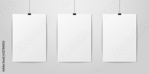 Three Vector Realistic White Blank Vertical A4 Paper Poster Hanging on a Rope with Binder Clip Set on White Wall mock-up. Empty Poster Design Template for Graphics, Mockup