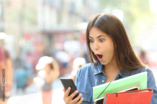 Surprised student girl watching phone content