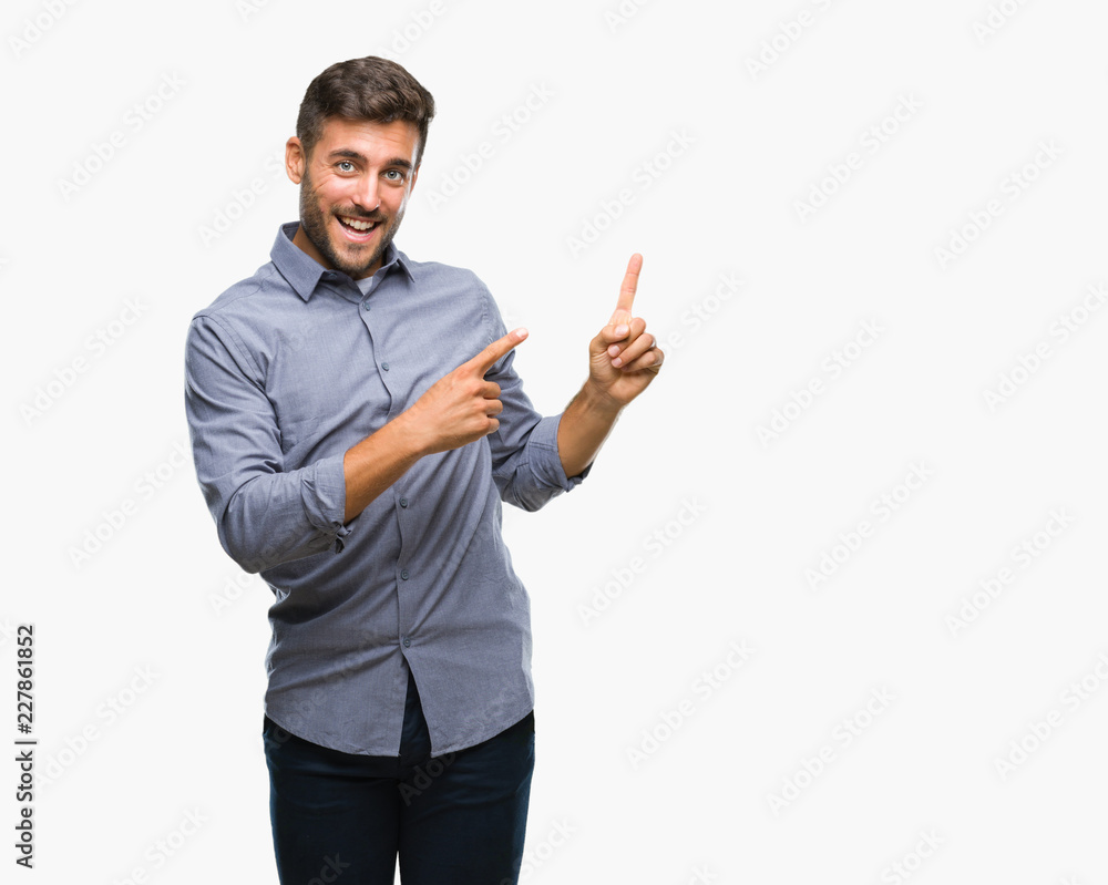 Young handsome man over isolated background smiling and looking at the camera pointing with two hands and fingers to the side. Young handsome man over isolated background smiling and looking at the camera pointing with two hands and fingers to the side.