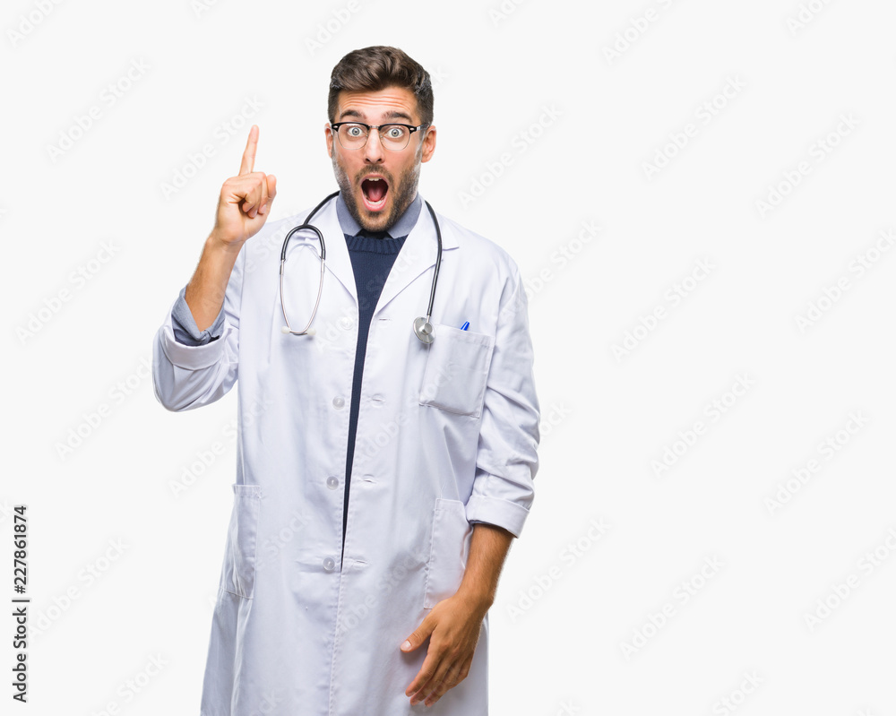 Young handsome doctor man over isolated background pointing finger up with successful idea. Exited and happy. Number one. Young handsome doctor man over isolated background pointing finger up with successful idea. Exited and happy. Number one.