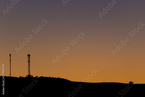 Communication/transmission towers at sunset