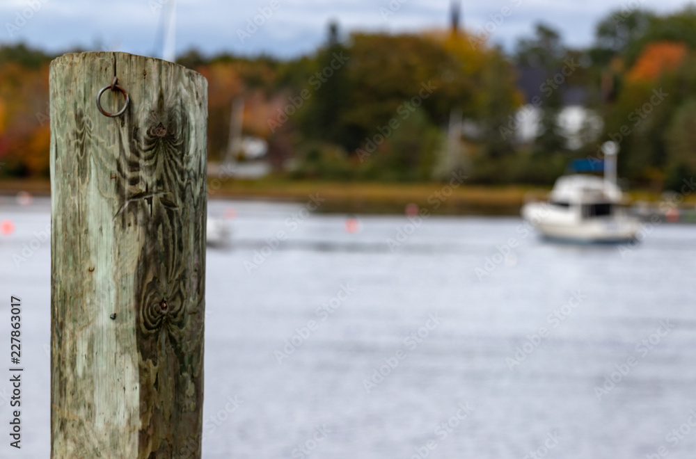 boat on the river blurred with post in focus to left of frame boat on the river blurred with post in focus to left of frame
