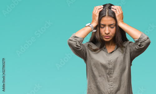 Young beautiful arab woman over isolated background suffering from headache desperate and stressed because pain and migraine. Hands on head.