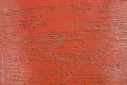 Wooden background. Old red paint on the wood texture