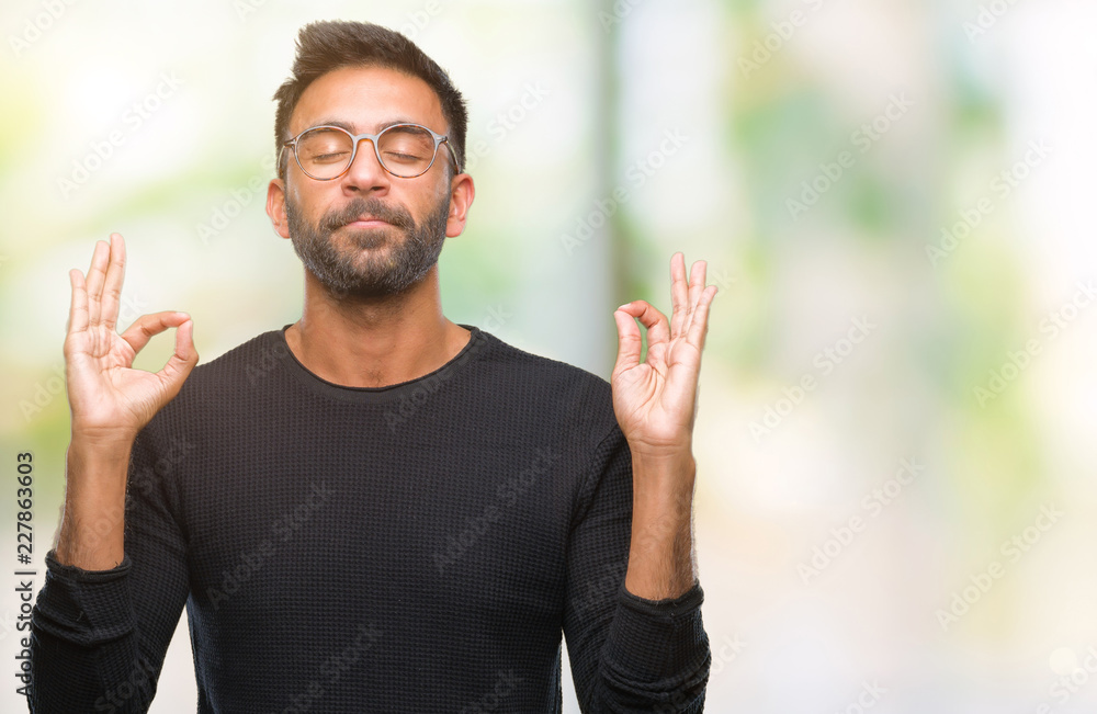 Adult hispanic man wearing glasses over isolated background relax and smiling with eyes closed doing meditation gesture with fingers. Yoga concept. Adult hispanic man wearing glasses over isolated background relax and smiling with eyes closed doing meditation gesture with fingers. Yoga concept.