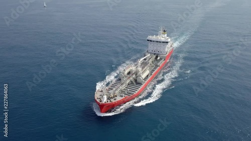 Large crude oil tanker roaring across The Mediterranean sea - Aerial footage following the ship