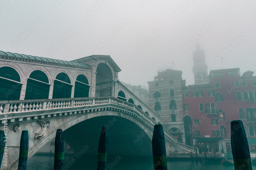 The iconic Rialto Bridge in Venice Italy on a foggy moody morning 