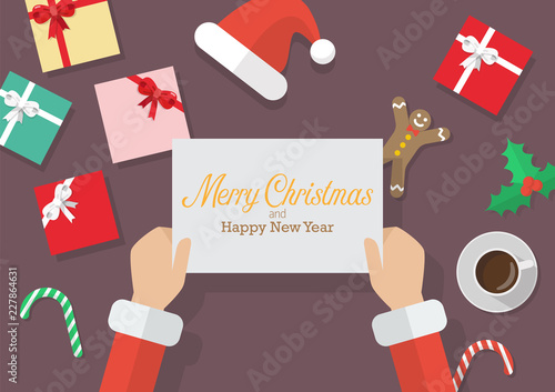 Santa Claus hands holding a Merry Christmas and Happy new year sign with Christmas decoration
